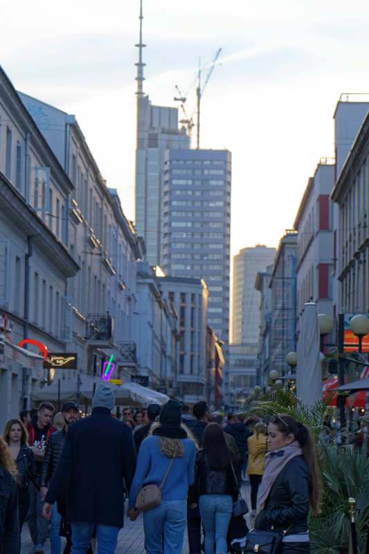 12 - A pedestrian street scene, Chmielna Street in Warsaw, Poland, featuring modern skyscrapers in the background